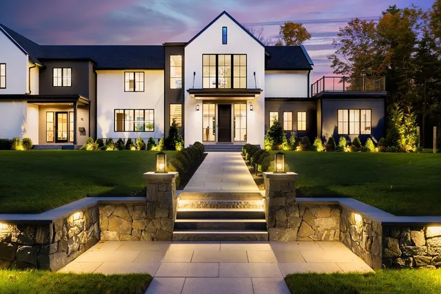 a front view of brick house with a yard