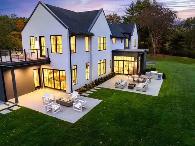 a front view of a house with a yard table and chairs