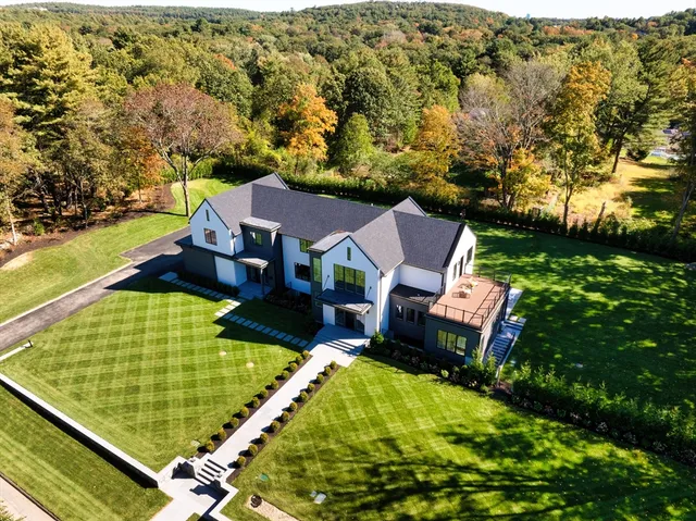 an aerial view of a house with a garden and swimming pool
