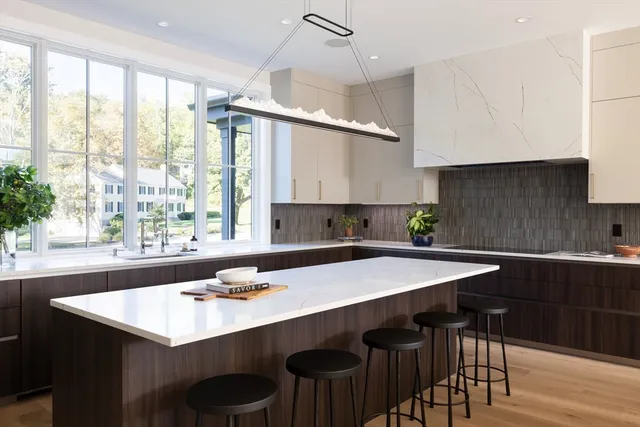 a kitchen with a table chairs sink and cabinets