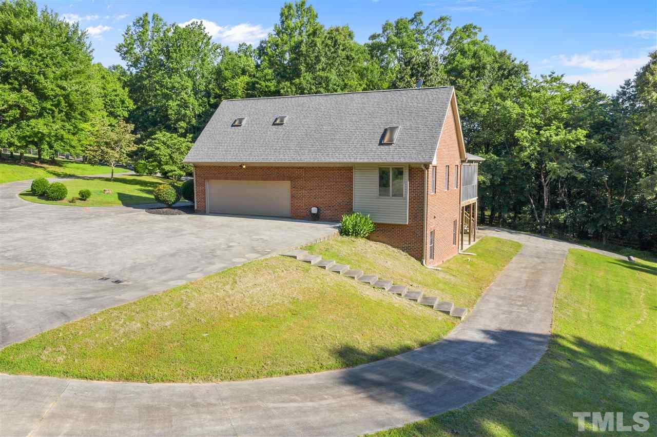 12804 Summerwind Trail Rougemont, NC 27572 - Photo 6 of 27 a aerial view of a house with swimming pool and trees in the background