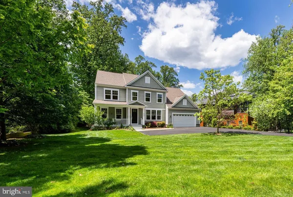 a front view of a house with yard and green space