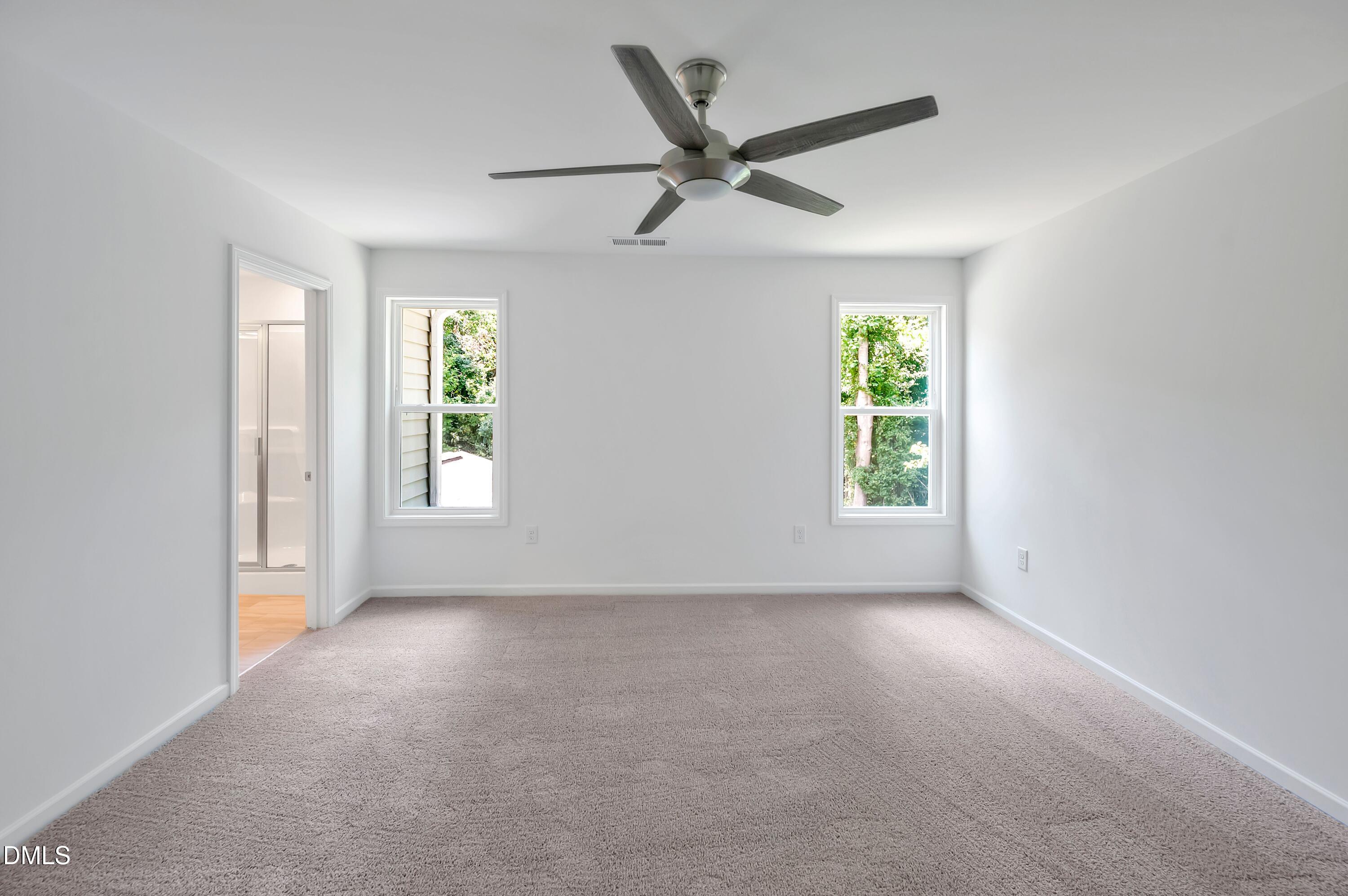 236 White Azalea Way Benson, NC 27504 - Photo 13 of 18 an empty room with windows and fan