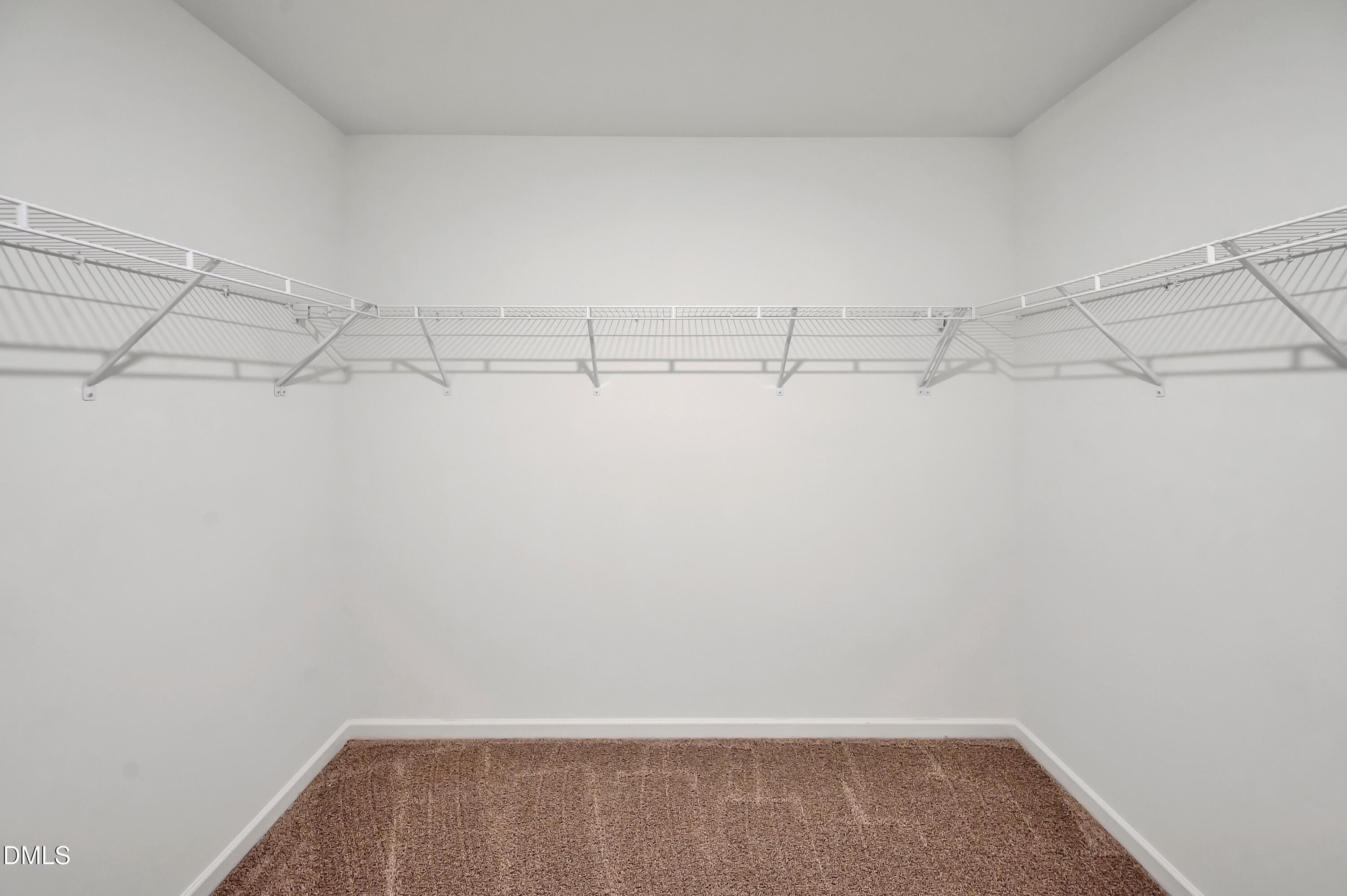 236 White Azalea Way Benson, NC 27504 - Photo 15 of 18 a view of a room with racks on the wall