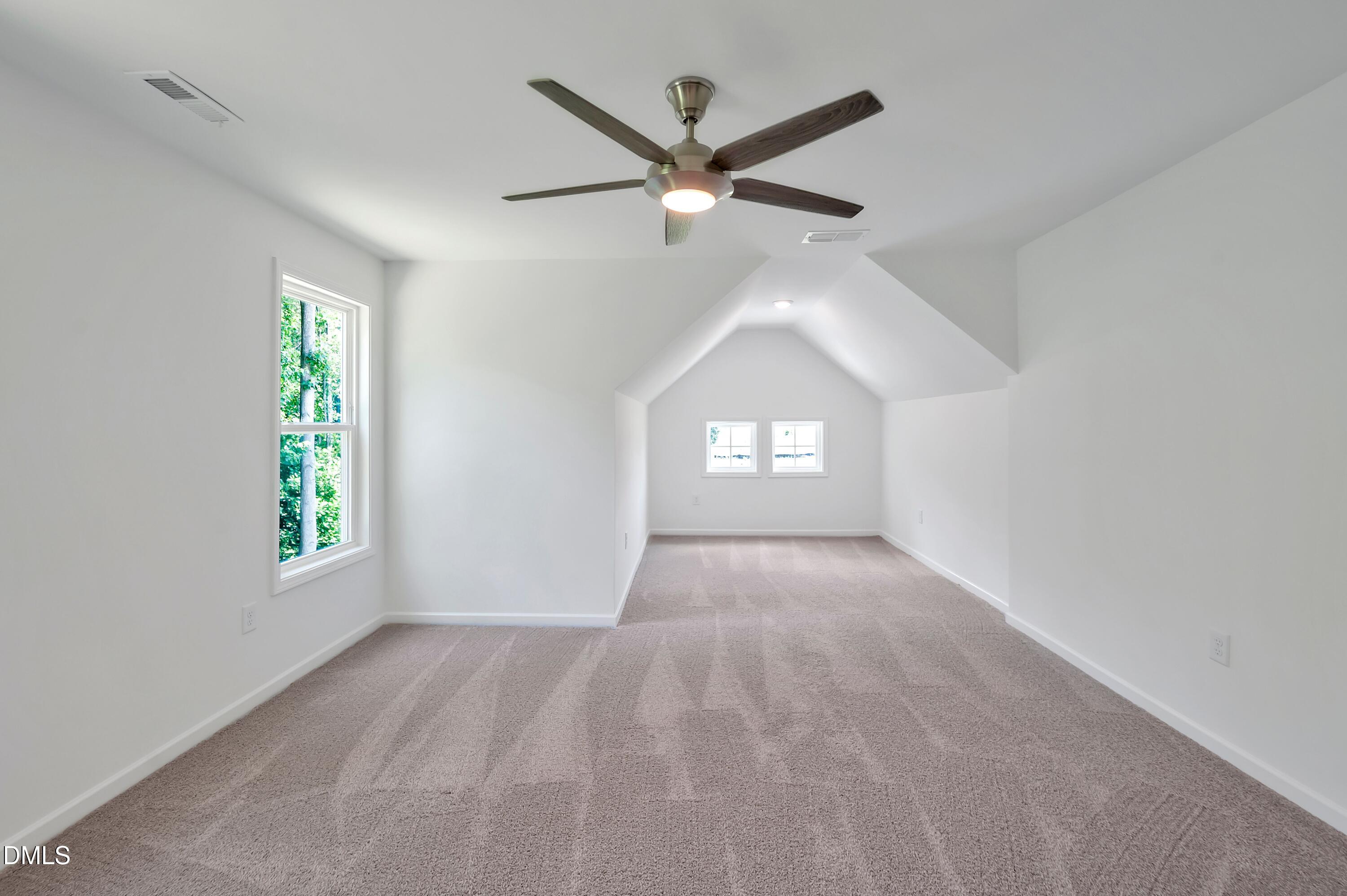 236 White Azalea Way Benson, NC 27504 - Photo 16 of 18 an empty room with windows and ceiling fan