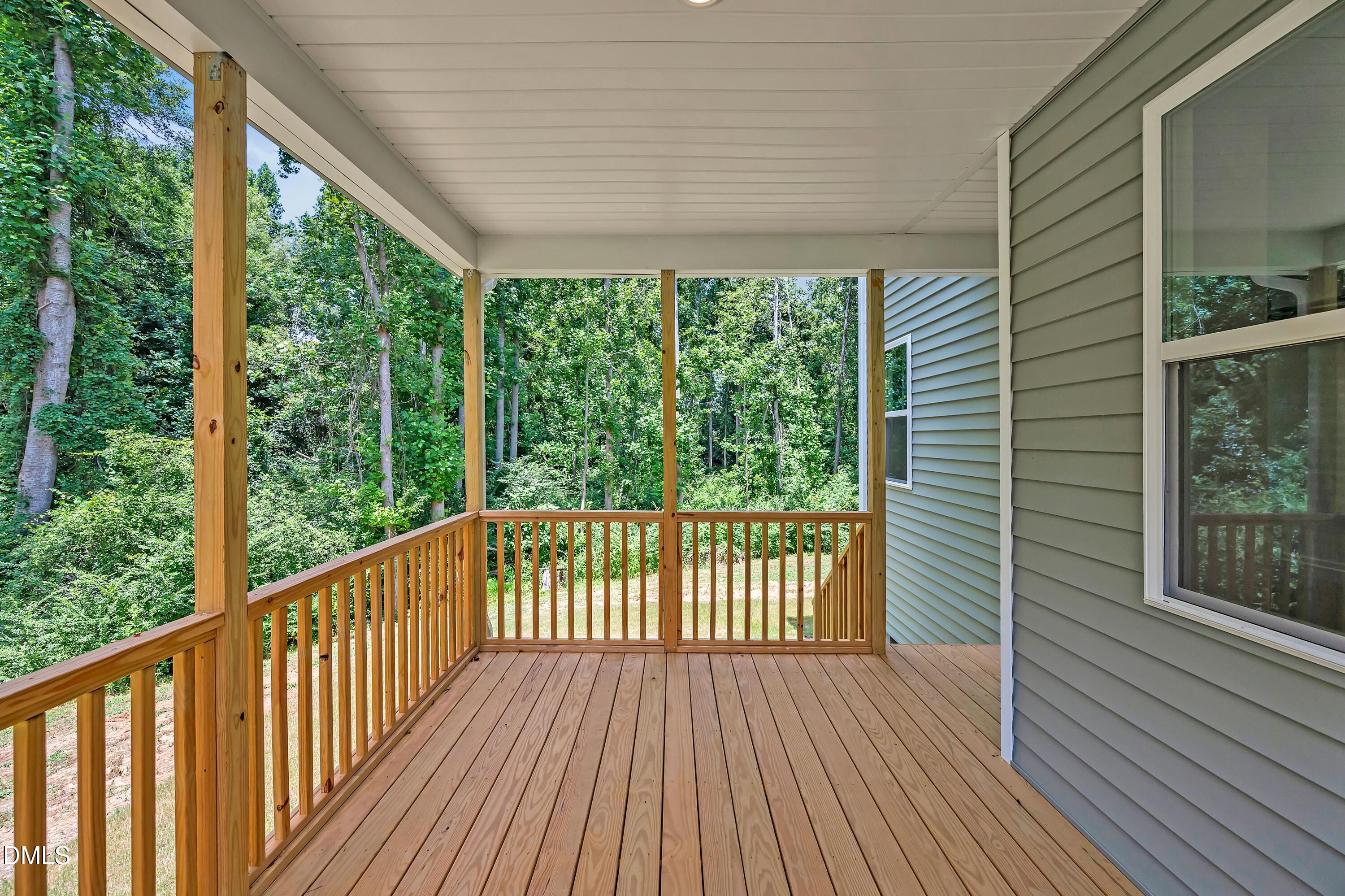 236 White Azalea Way Benson, NC 27504 - Photo 18 of 18 a view of a balcony with wooden floor