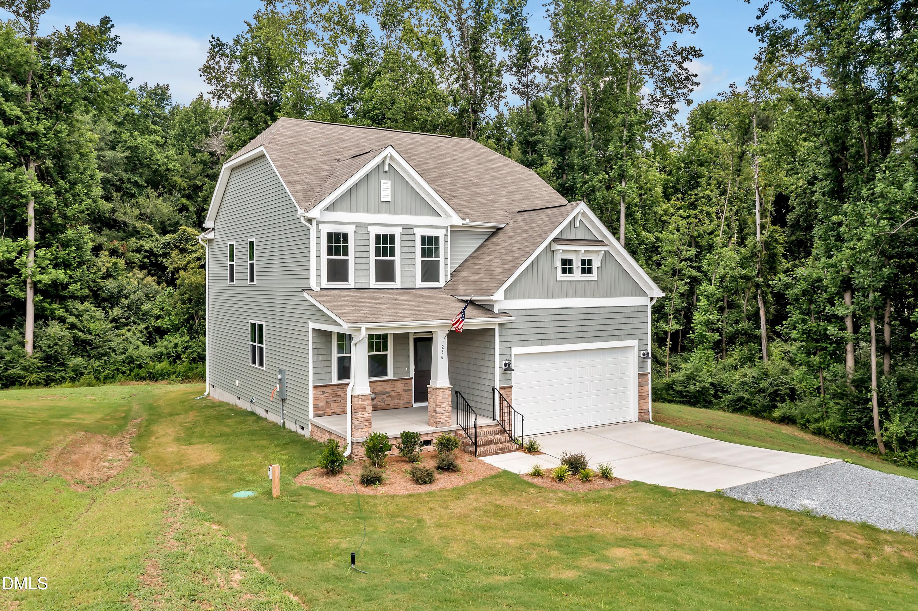 236 White Azalea Way Benson, NC 27504 - Photo 2 of 18 a front view of a house with a yard