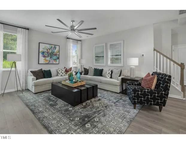 a living room with furniture wooden floor and window