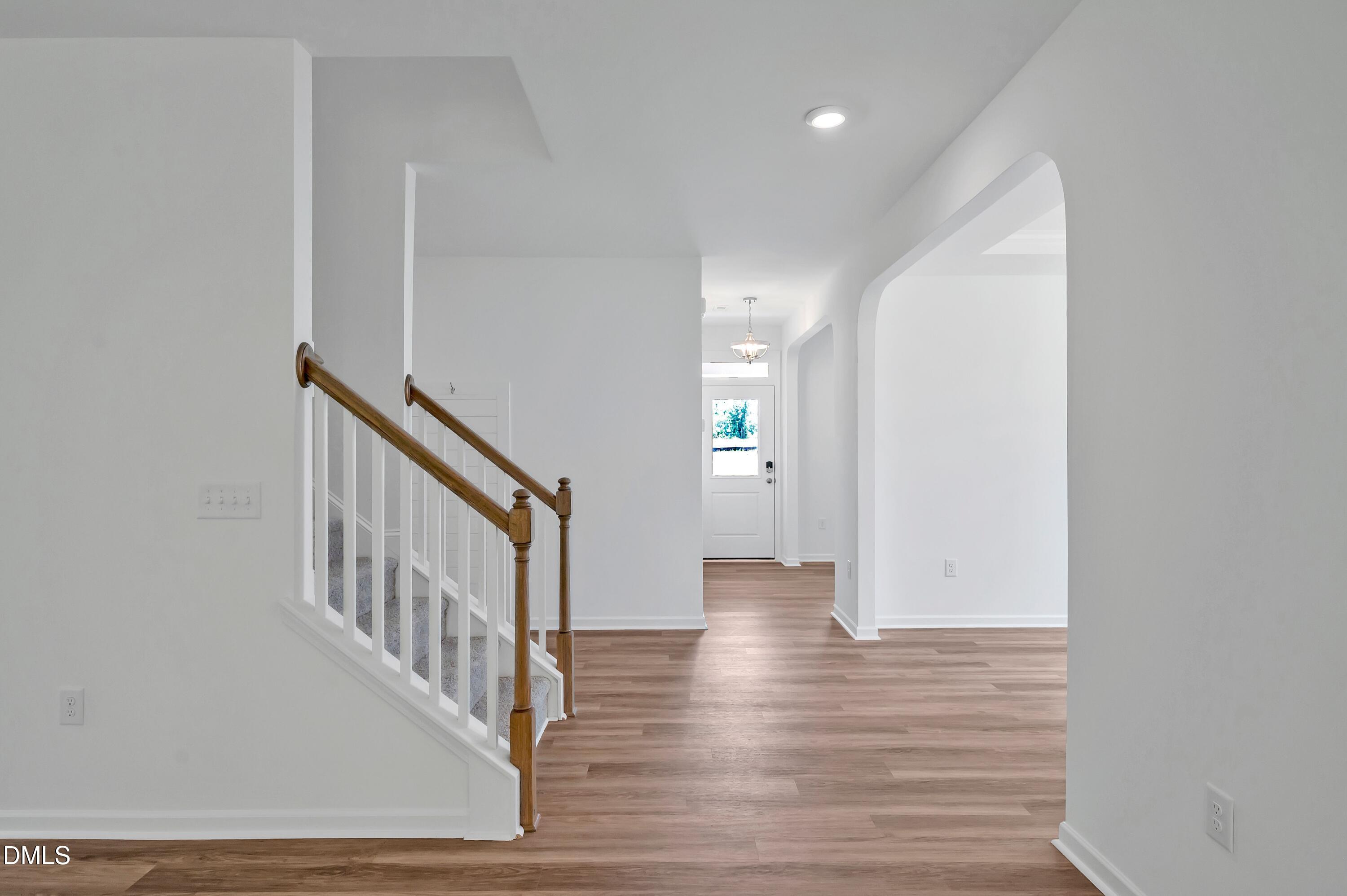236 White Azalea Way Benson, NC 27504 - Photo 5 of 18 a view of a hallway with wooden floor and entryway
