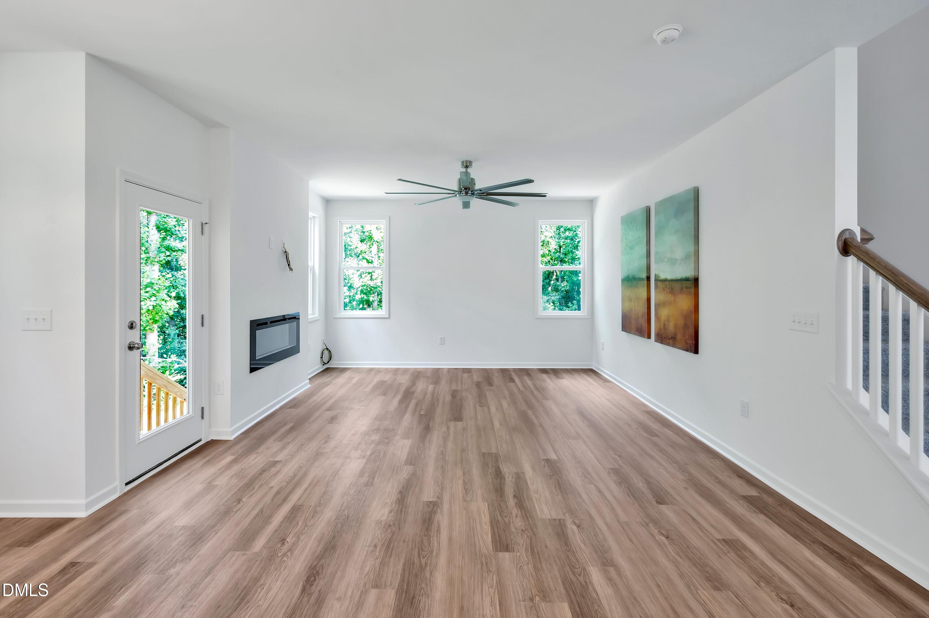 236 White Azalea Way Benson, NC 27504 - Photo 9 of 18 wooden floor in an empty room with a window