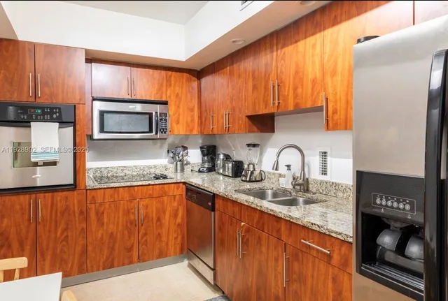 a kitchen with stainless steel appliances granite countertop a sink microwave and stove
