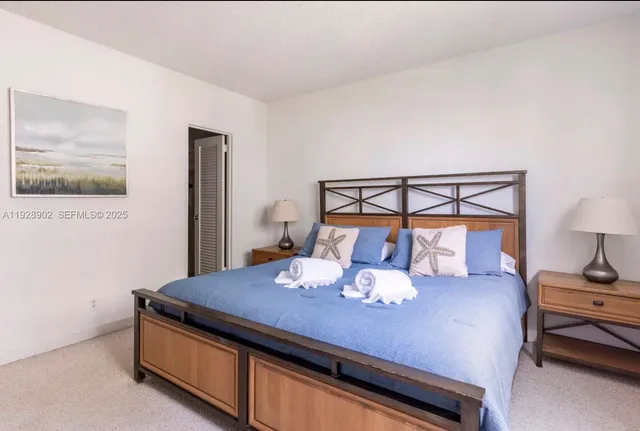 a bedroom with a bed and a lamp on table