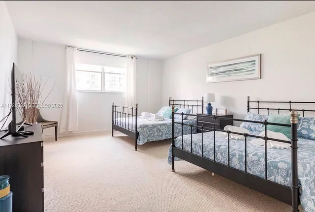 a view of a bedroom with furniture and a window