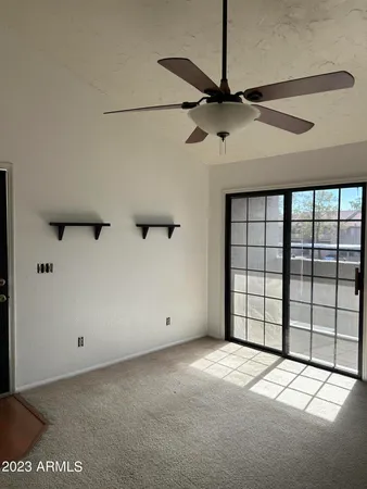 a view of a livingroom with a ceiling fan and window