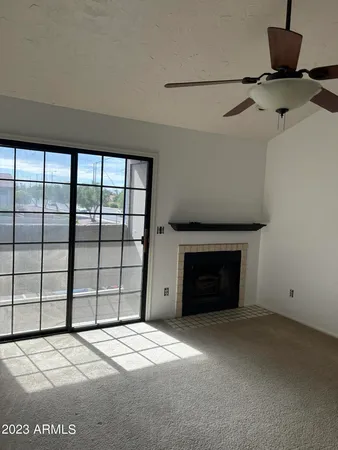 a view of empty room with window and fireplace