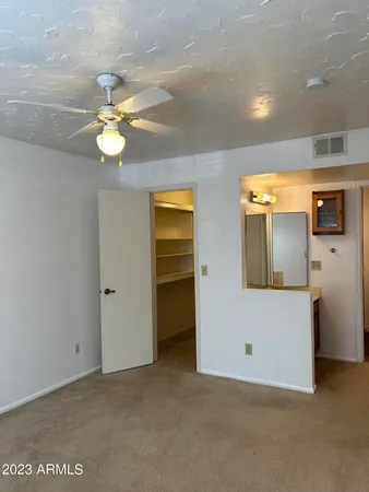 a bathroom with a granite countertop sink toilet and mirror