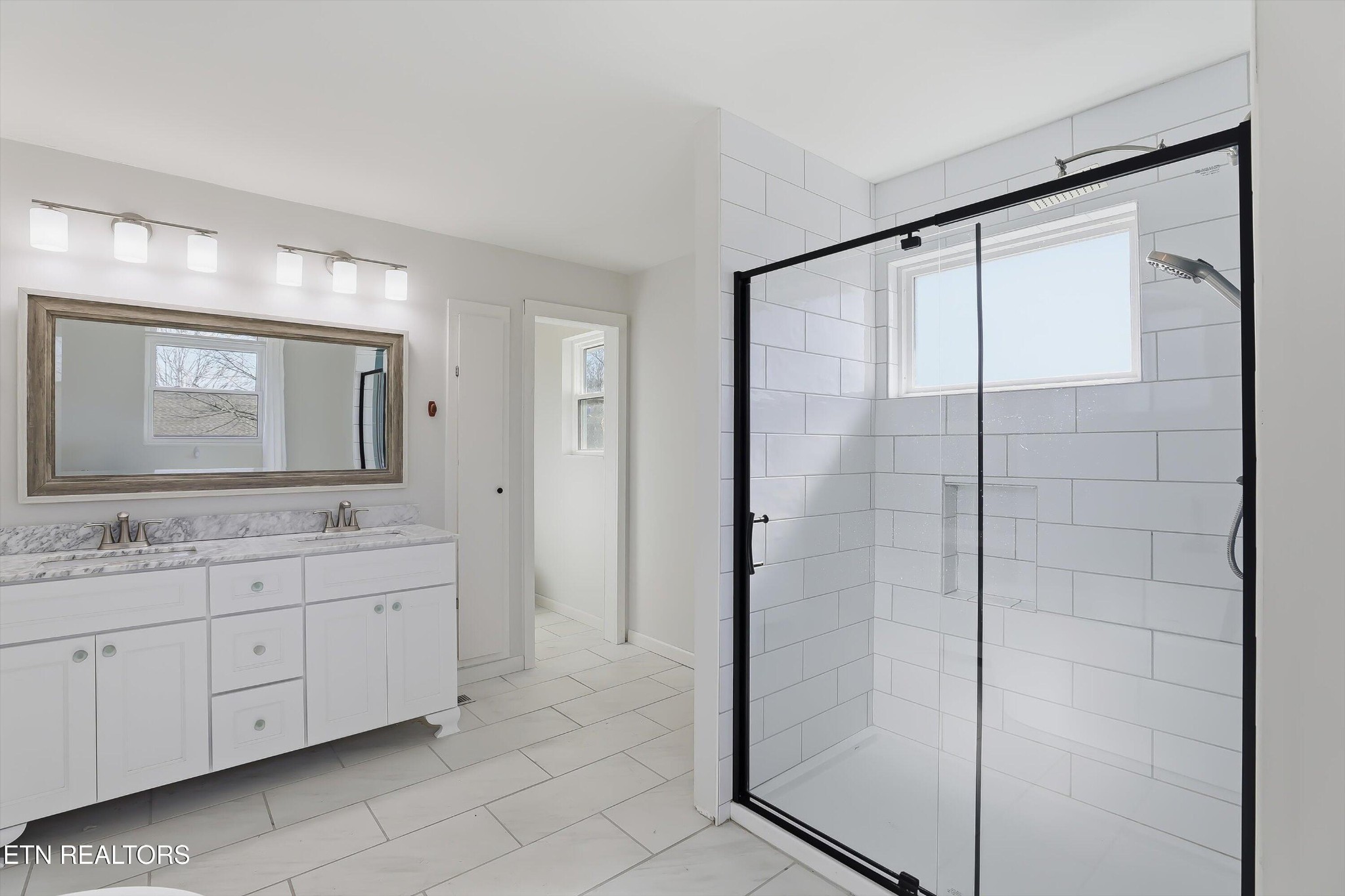 6120 Cline Road Knoxville, TN 37938 - Photo 16 of 29 a bathroom with a double vanity sink and mirror