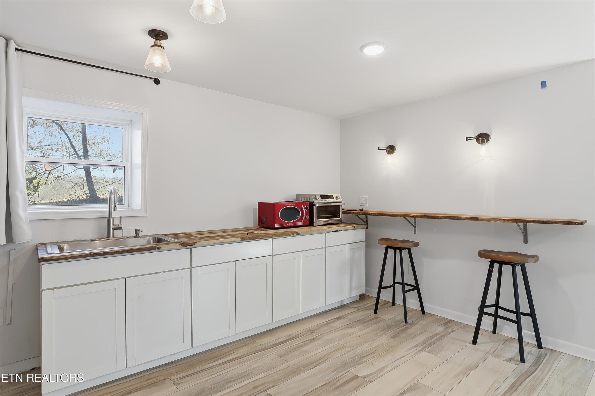 6120 Cline Road Knoxville, TN 37938 - Photo 19 of 29 a kitchen with sink cabinets and wooden floor