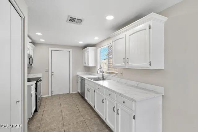 a kitchen with sink cabinets and window