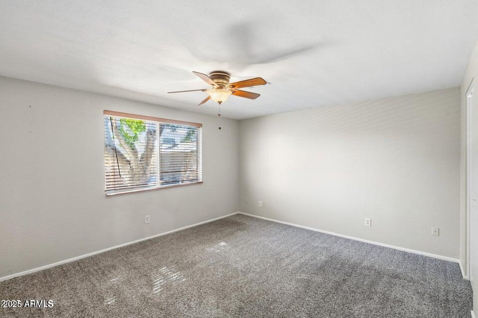 1525 West El Alba Way Chandler, AZ 85224 - Photo 22 of 33 an empty room with windows and fan