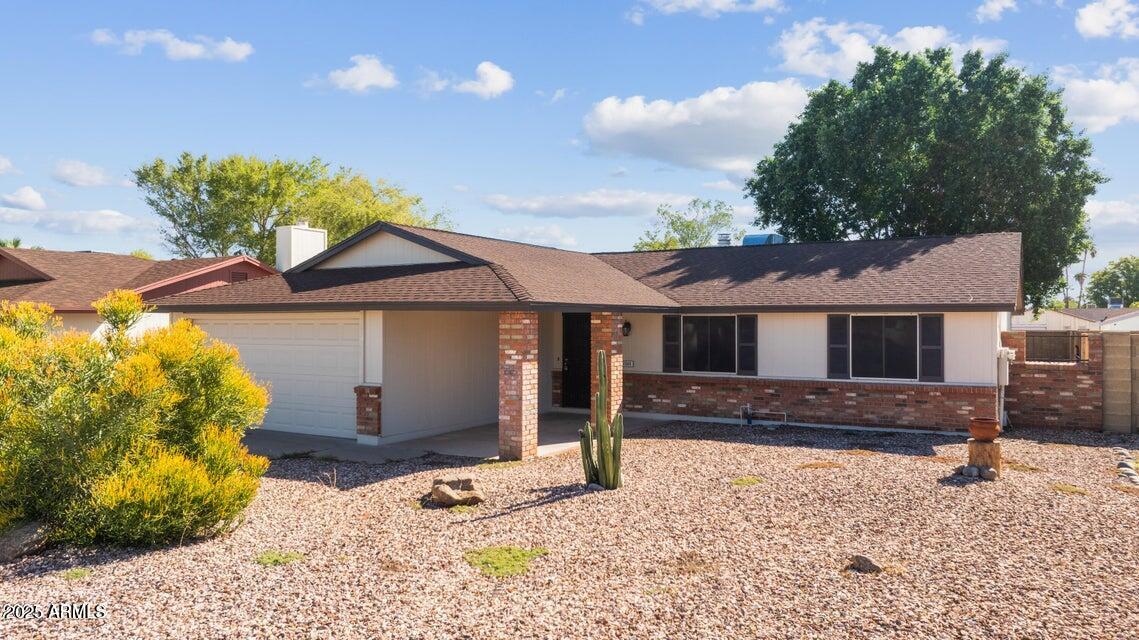 1525 West El Alba Way Chandler, AZ 85224 - Photo 3 of 33 a front view of a house with a yard and garage