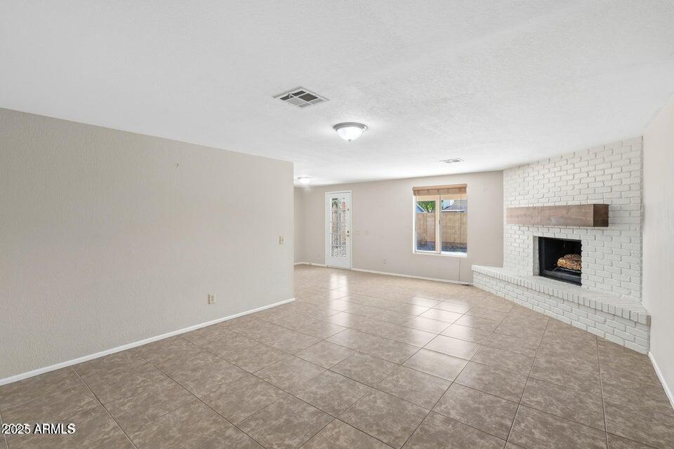 1525 West El Alba Way Chandler, AZ 85224 - Photo 8 of 33 wooden floor in an empty room with a fireplace