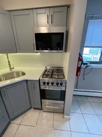 a kitchen with stainless steel appliances a stove and a microwave