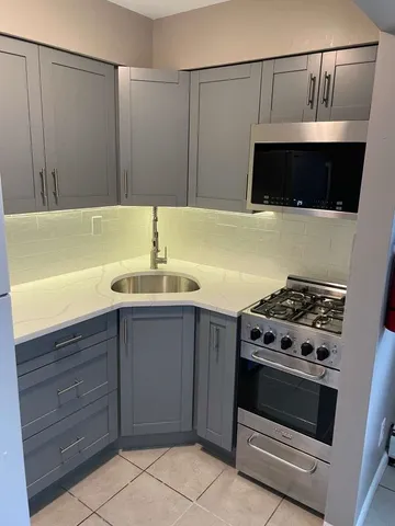 a kitchen with stainless steel appliances a refrigerator sink and stove