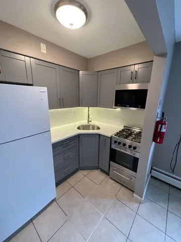 a view of an empty room with a fireplace