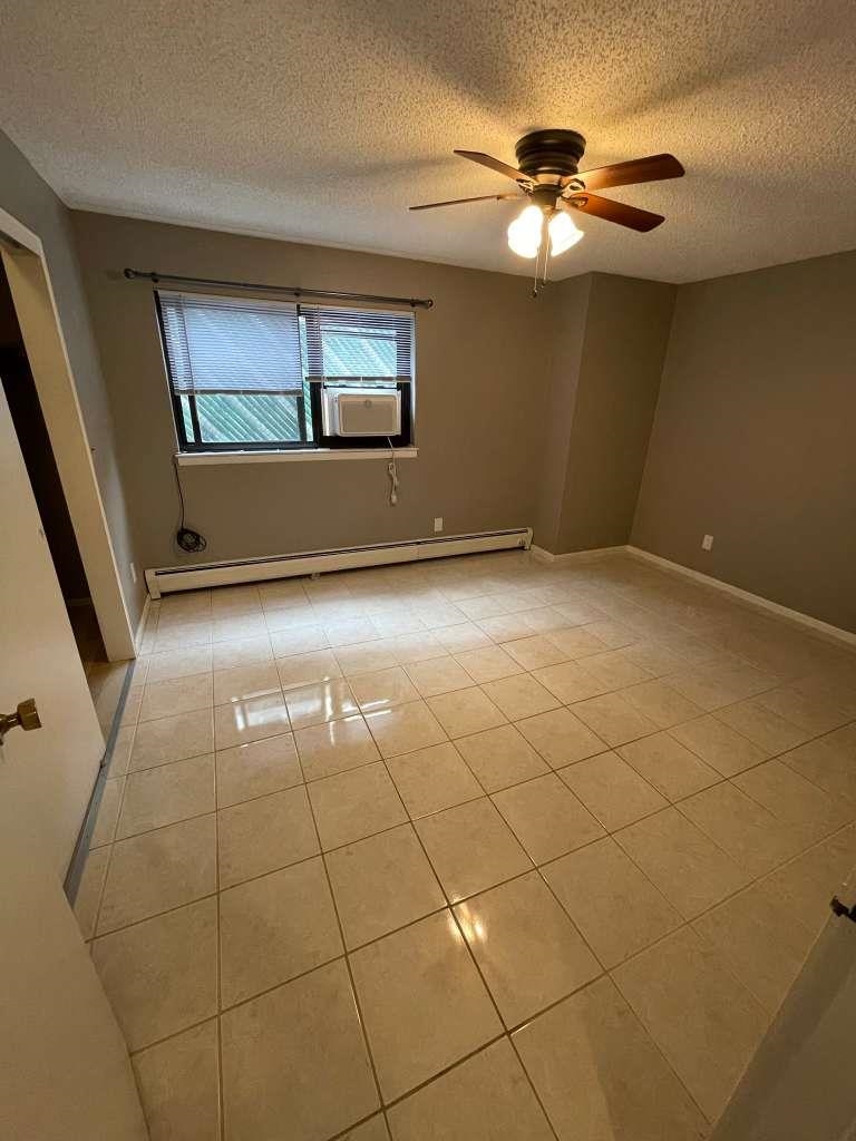 17 68th Street, Unit 7 Guttenberg, NJ 07093 - Photo 21 of 30 wooden floor in an empty room with a window