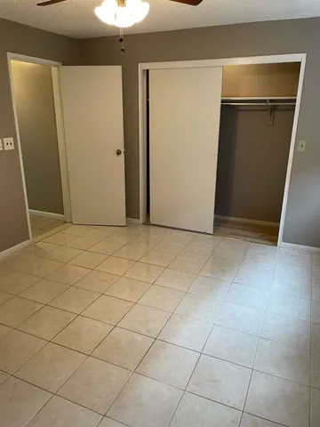a view of a livingroom with an empty space and closet