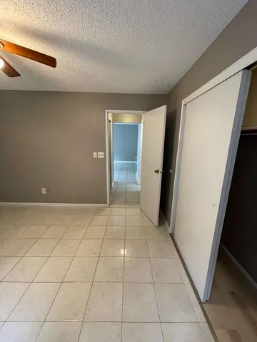 a view of hallway with stairs and a window