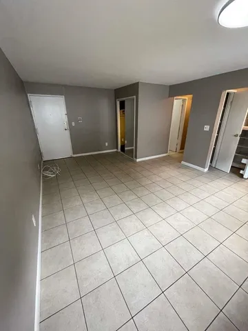 an empty room with fireplace and windows