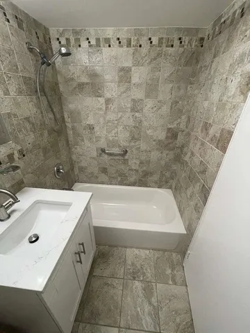 a bathroom with a toilet sink a mirror and shower