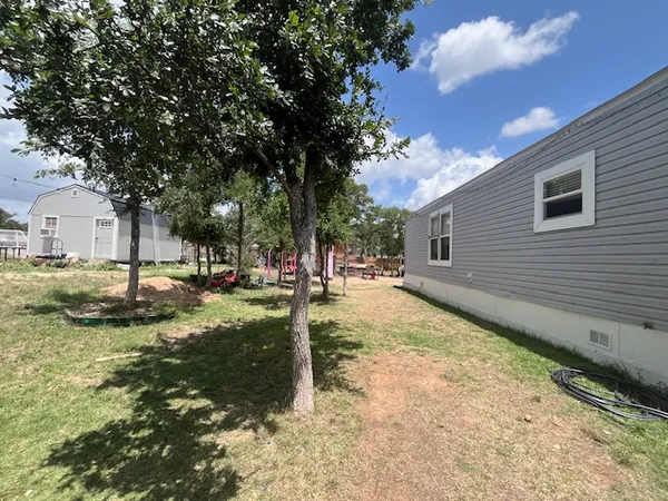 a view of a yard with swimming pool