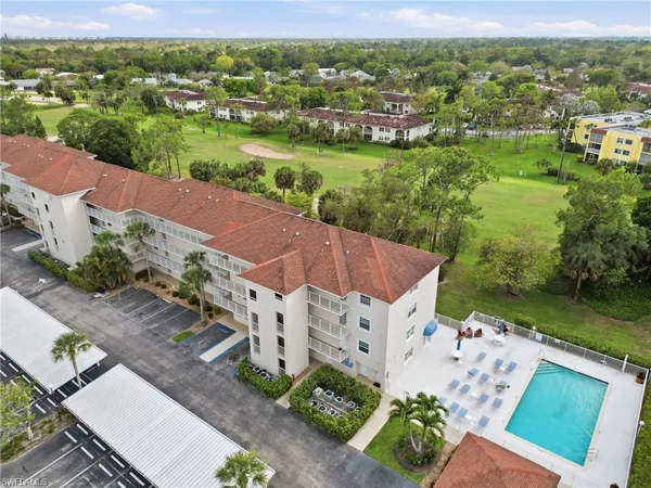 an aerial view of residential houses with outdoor space and street view