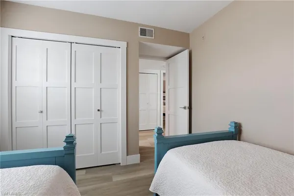 a bedroom with a bed and a closet
