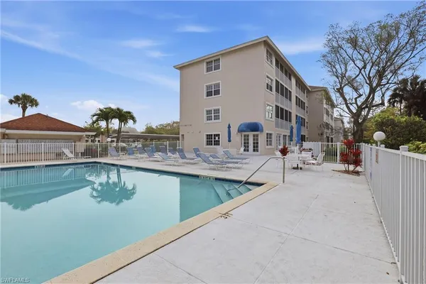 a view of a house with pool table and chairs