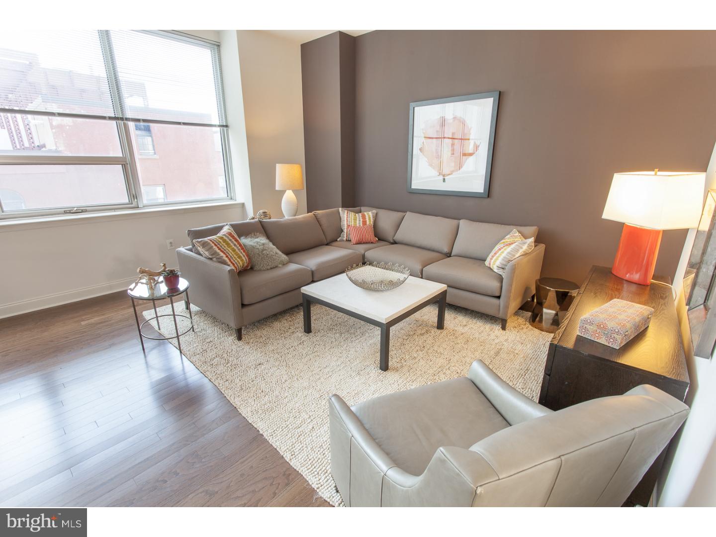 811-1 Filbert Street, Unit 618 Philadelphia, PA 19107 - Photo 13 of 18 a living room with furniture and a window
