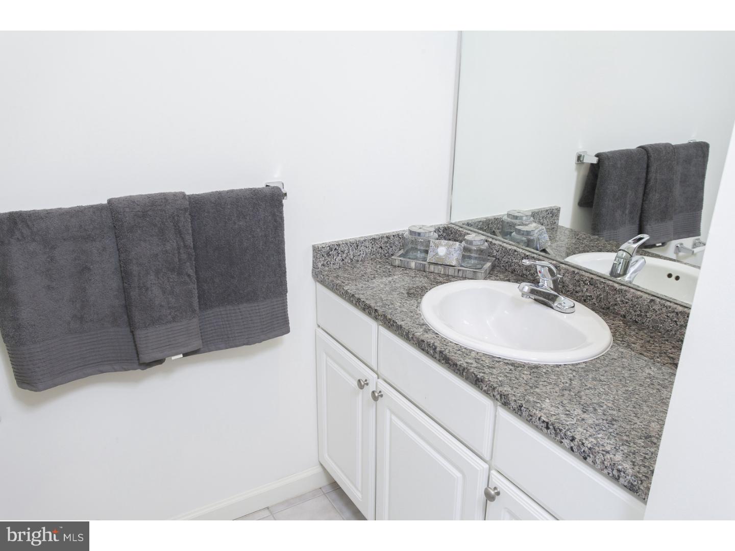 811-1 Filbert Street, Unit 618 Philadelphia, PA 19107 - Photo 18 of 18 a bathroom with a sink and a mirror