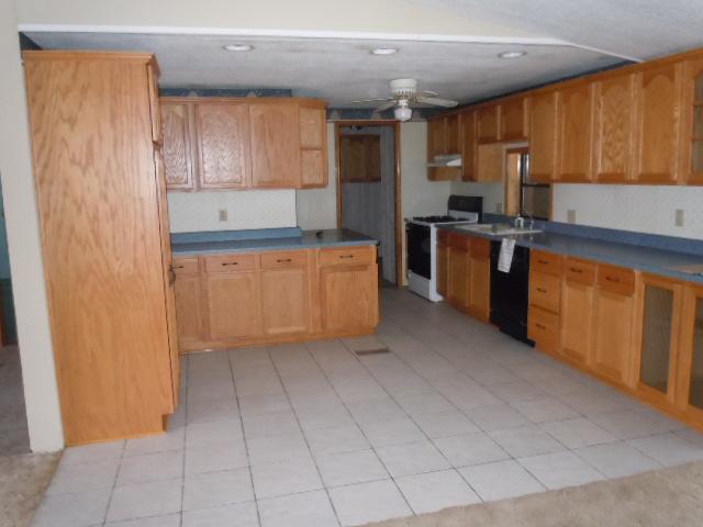 10948 Moate Road Durand, IL 61024 - Photo 5 of 12 a kitchen with stainless steel appliances granite countertop a refrigerator and a sink