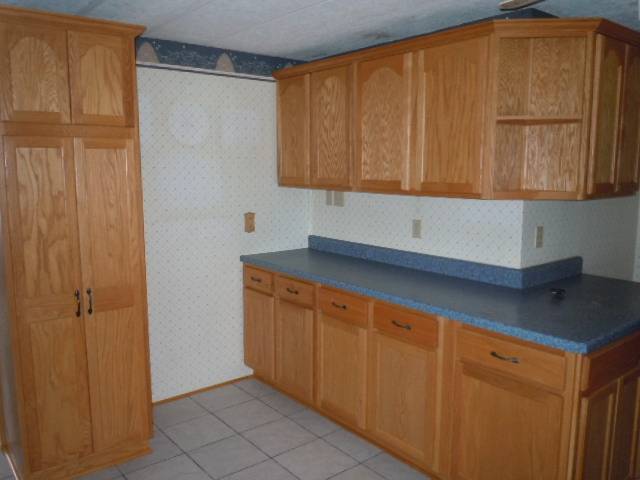 10948 Moate Road Durand, IL 61024 - Photo 6 of 12 a kitchen with a refrigerator and cabinets