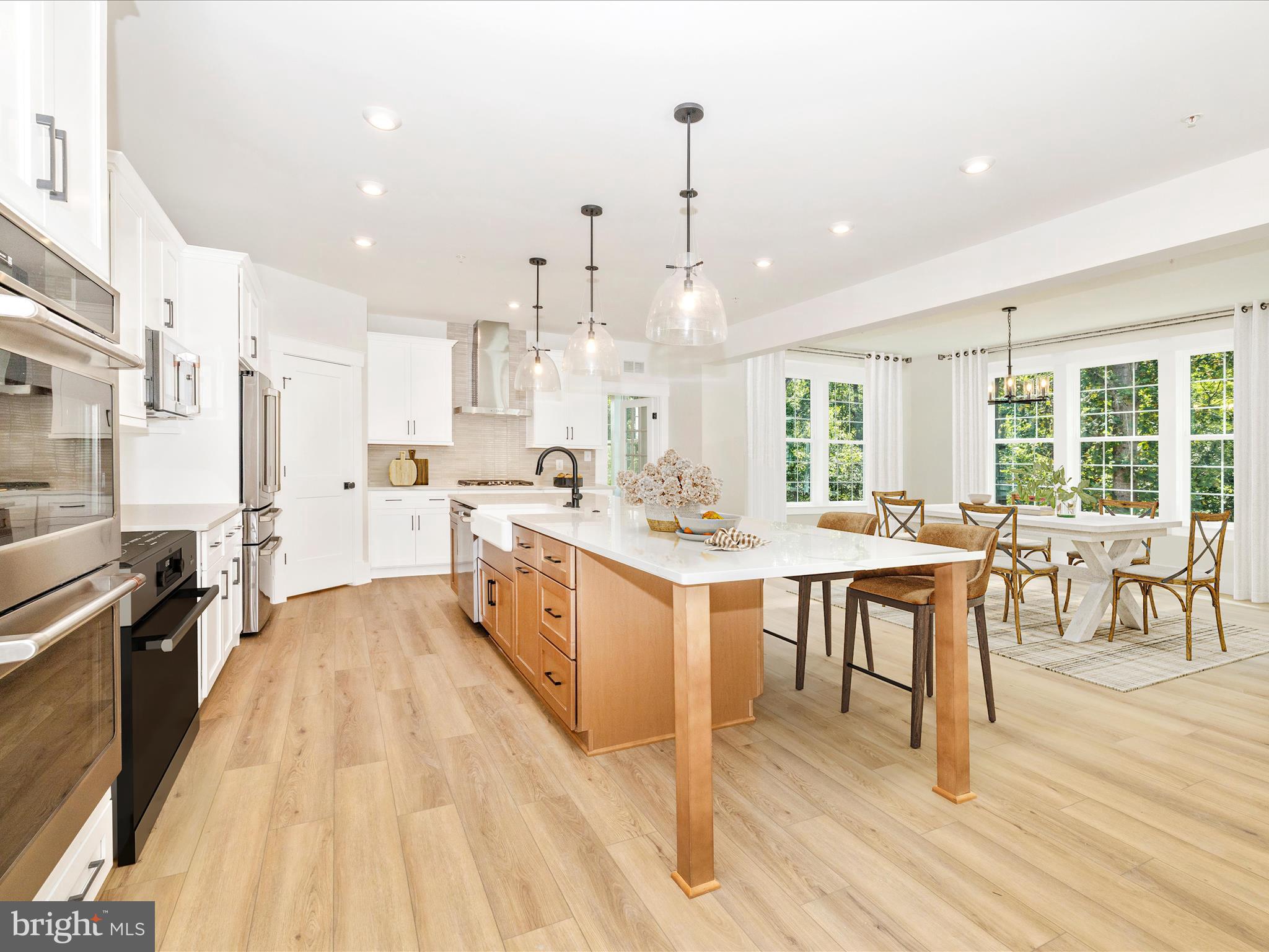 3105 Sumantown Road Middletown, MD 21769 - Photo 11 of 45 a large white kitchen with lots of counter space dining table and stainless steel appliances