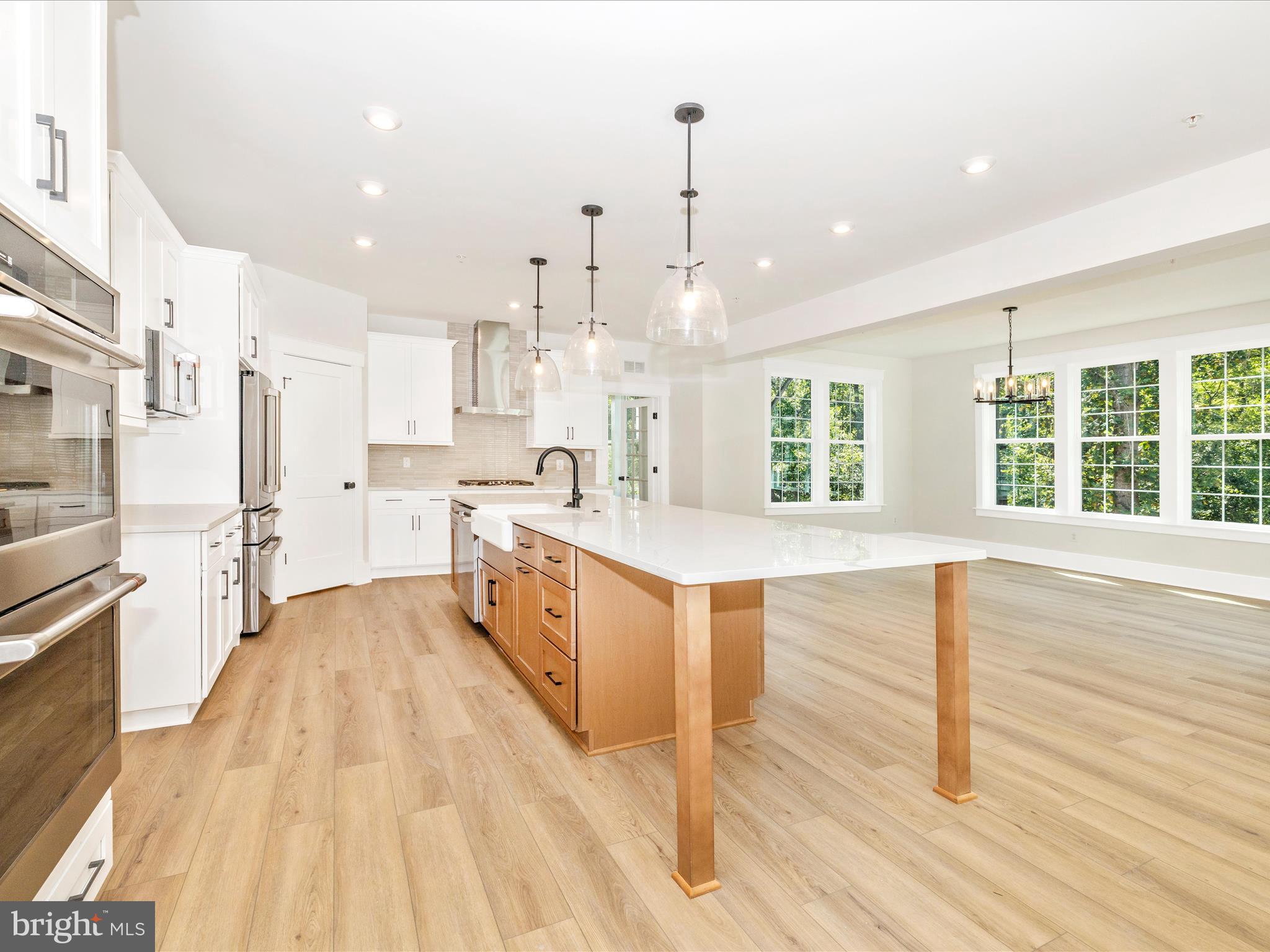 3105 Sumantown Road Middletown, MD 21769 - Photo 12 of 45 a large kitchen with kitchen island white cabinets and stainless steel appliances