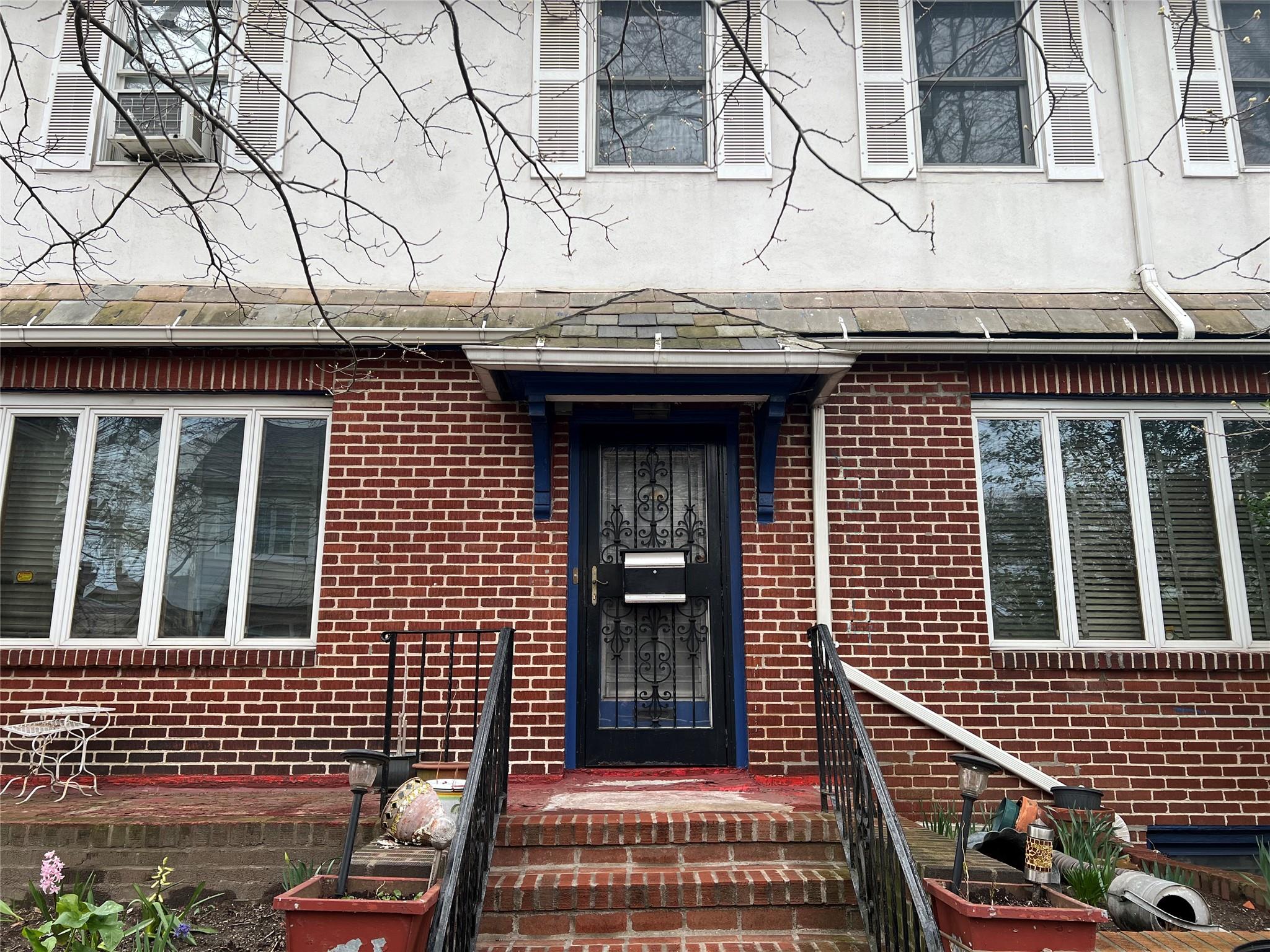 160-16 Riverside Drive Queens, NY 11357 - Photo 4 of 11 a view of brick house with large windows