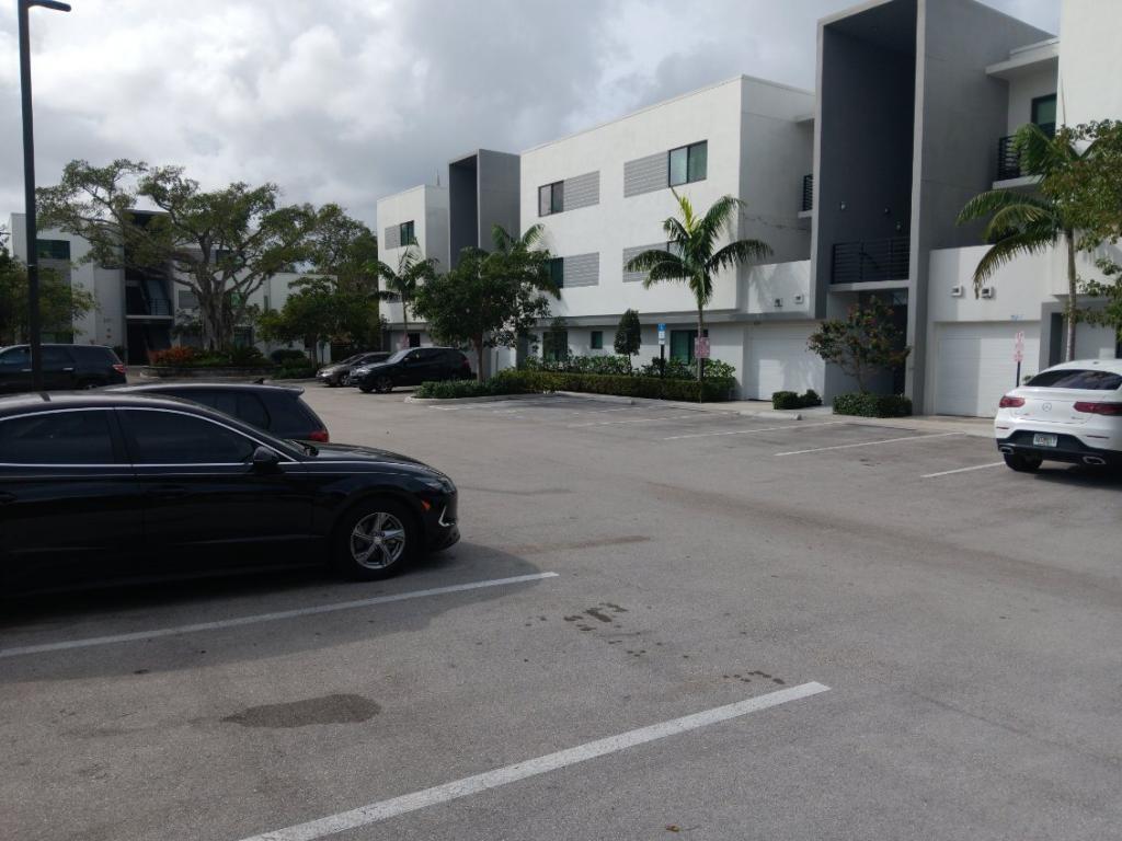 3050 Northwest 68th Street, Unit 2205 Fort Lauderdale, FL 33309 - Photo 2 of 19 a car parked in front of a house