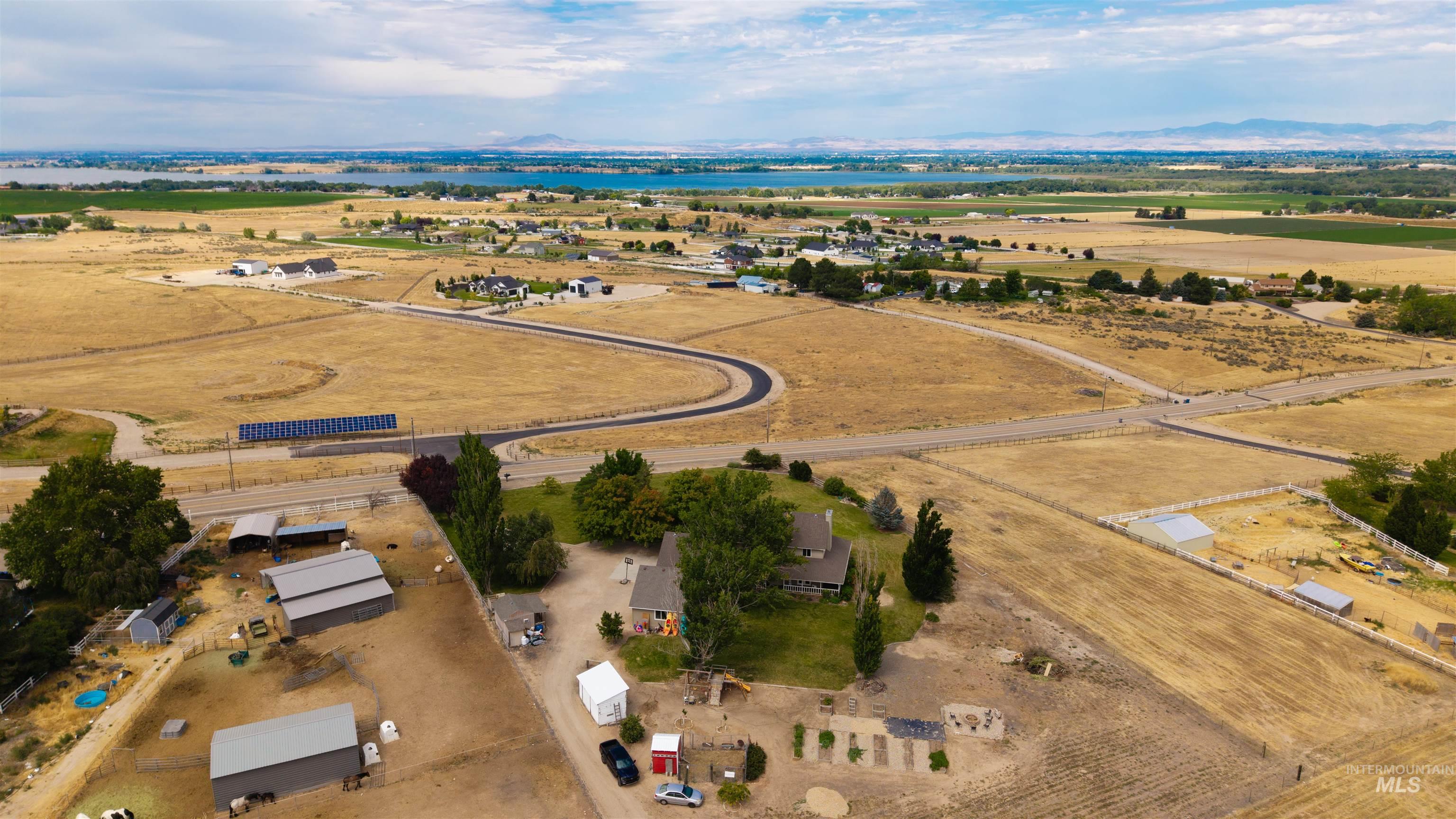 12369 Deer Flat Road Nampa, ID 83686 - Photo 46 of 50 Expansive aerial encompassing a large residential property with multiple outbuildings, fenced areas, and a primary residence