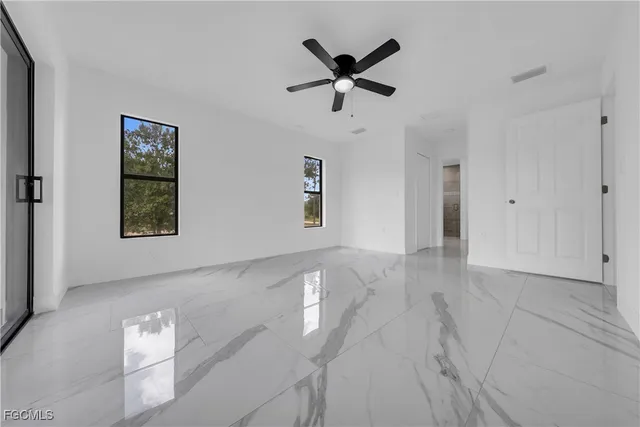 a view of a livingroom with a ceiling fan and window