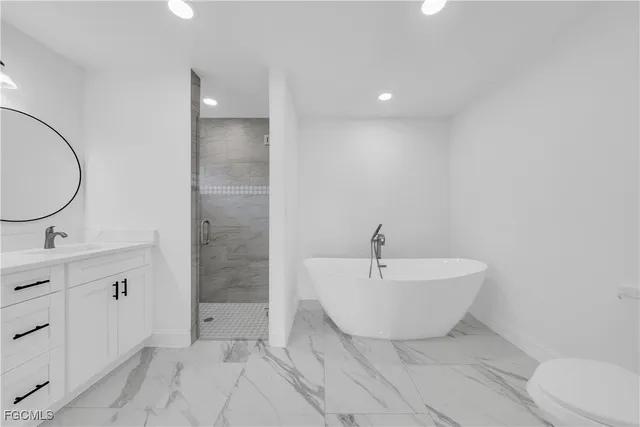 a spacious bathroom with a bathtub and sink