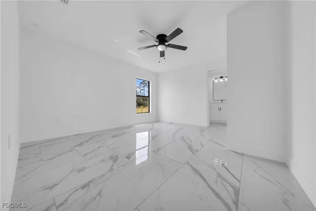 a view of a livingroom with a ceiling fan and window